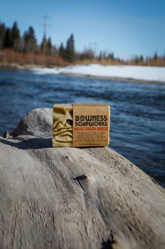 Bar of soap from Bowness Soapworks on a rock by a lake
