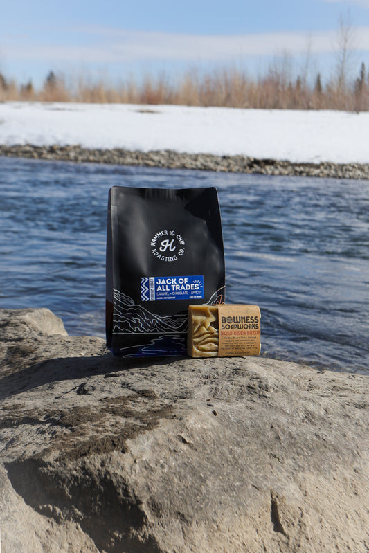 A bag of coffee besides a bar of soap.
