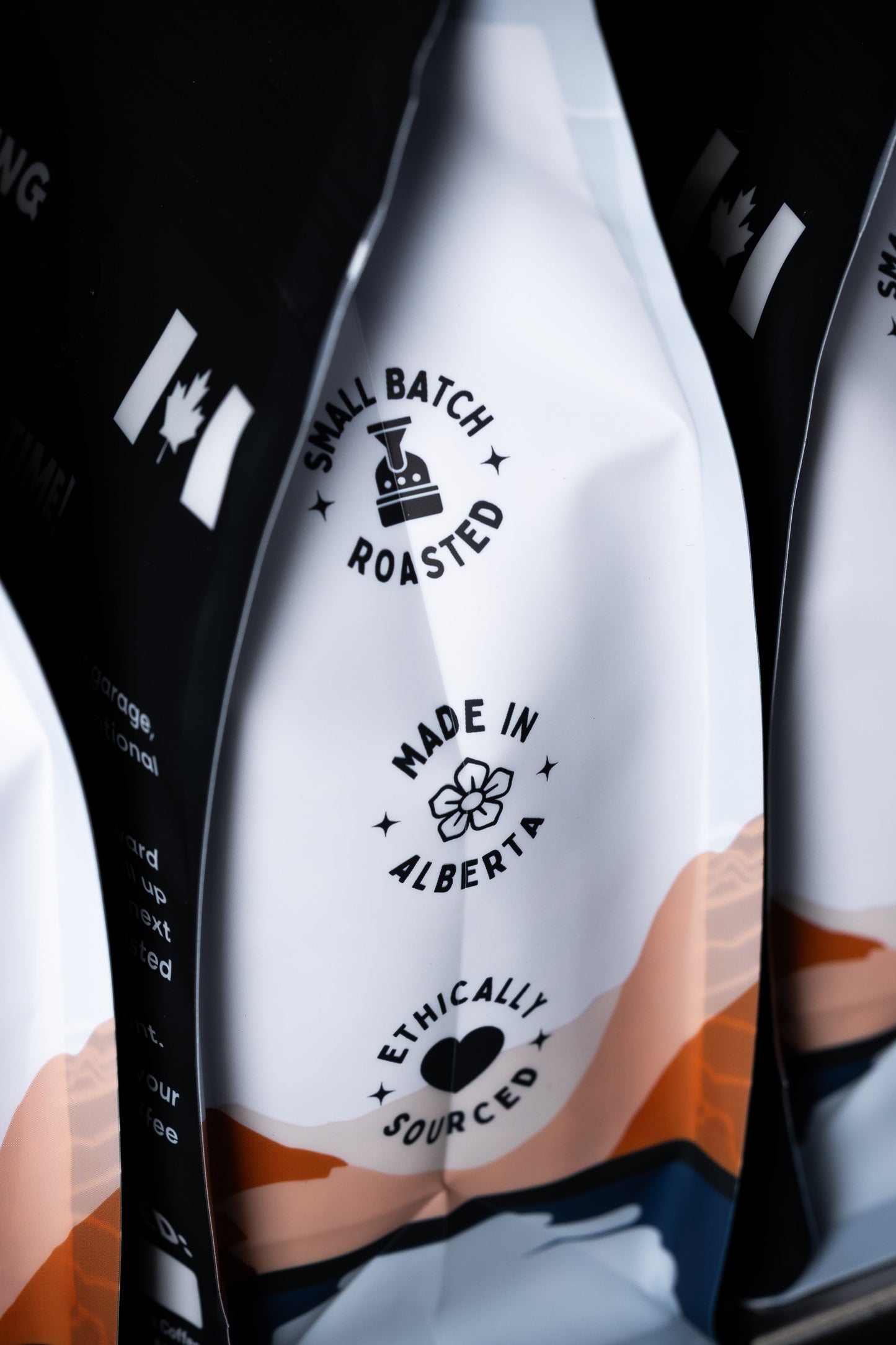 Three coffee bags with branding and text on a black background